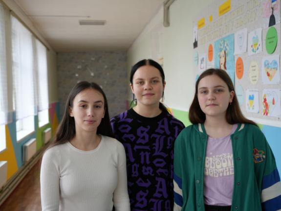 From left to right: Friends Zenhya, 17, Amina, 14, and Nastya, 15, return to a safe and refurbished school