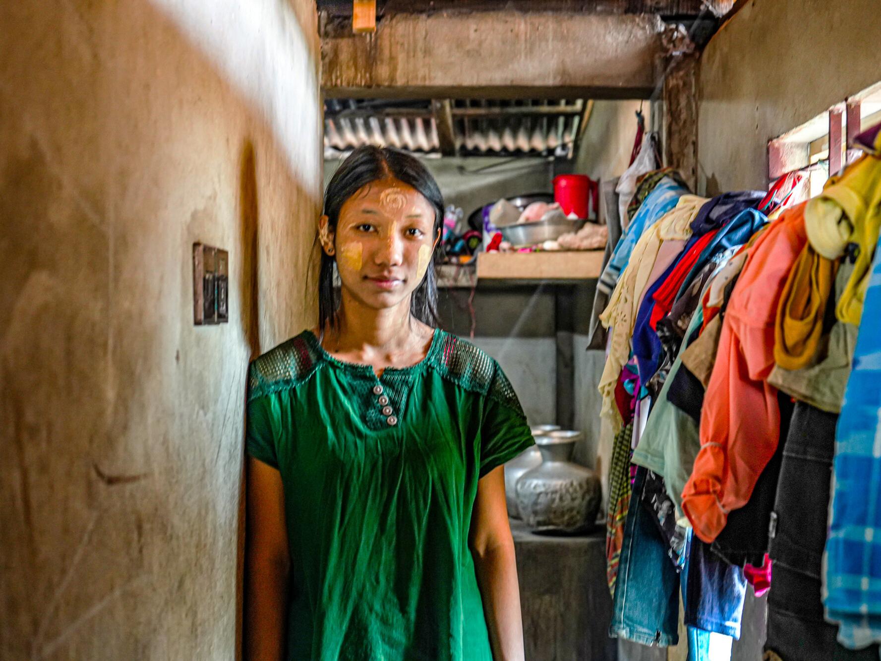 Useaking, 21, standing in her home in Bangladesh. 