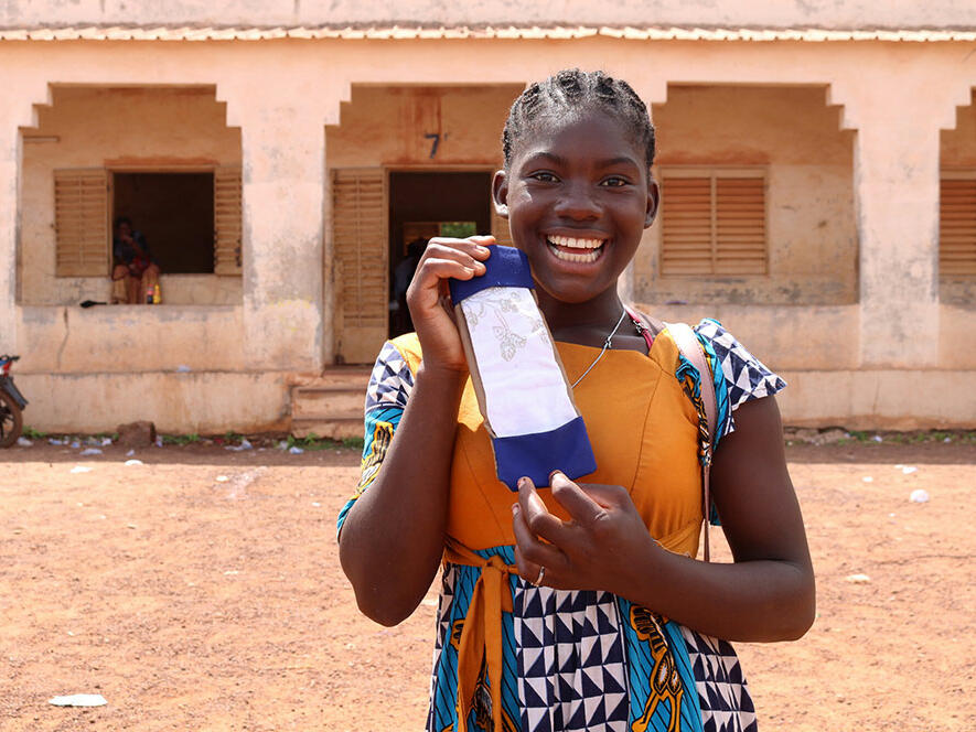 Kologo from Mail Kologo from Mali holds up a reusable sanitary pad she made in a workshop