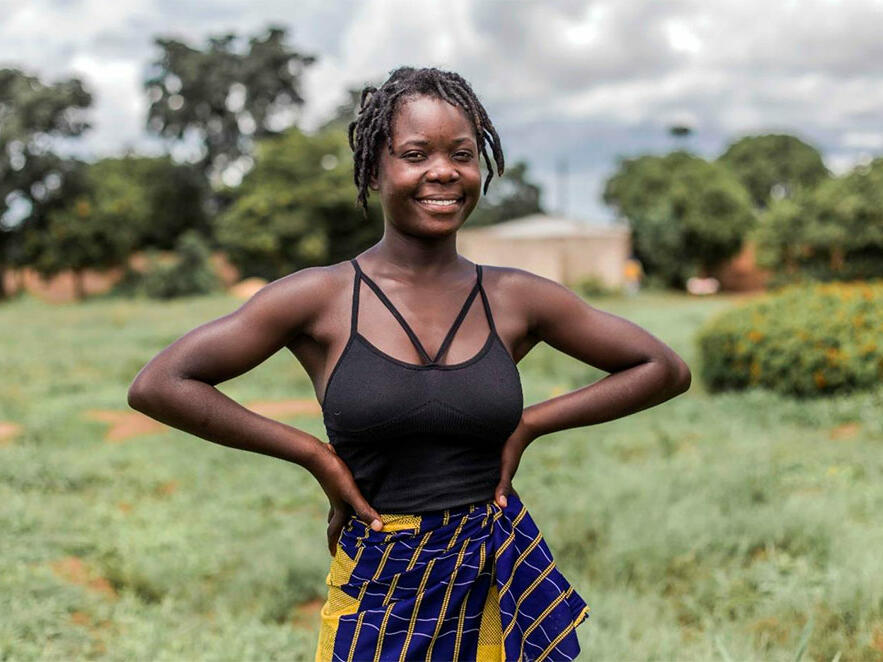 Mary, 18, from Zambia standing outside smiling at the camera