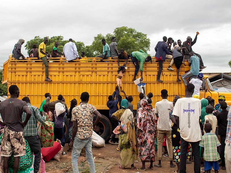 Large trucks transport people to and from the transit centre in Renk, South Sudan.