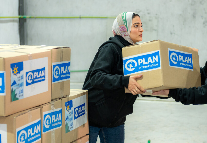 Plan staff prepare boxes of first aid kits ready for transport to Gaza  