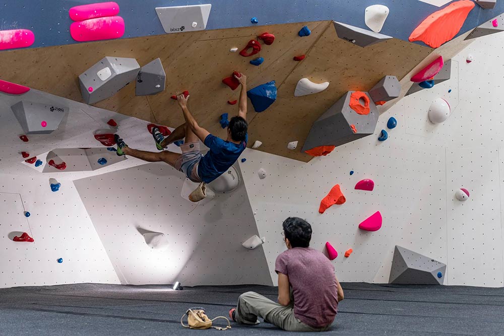 Two young men practicing on a climbing wall