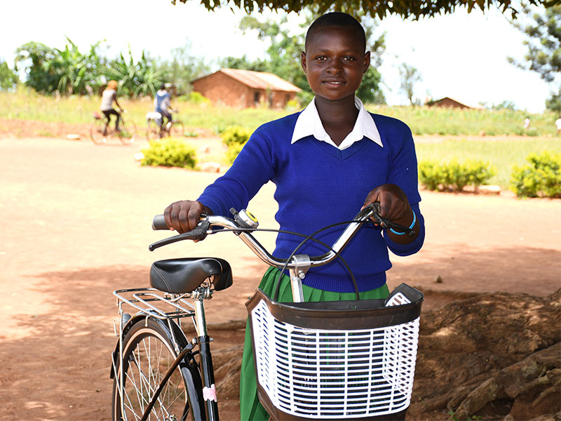 Girl outside in in school uniform with bike