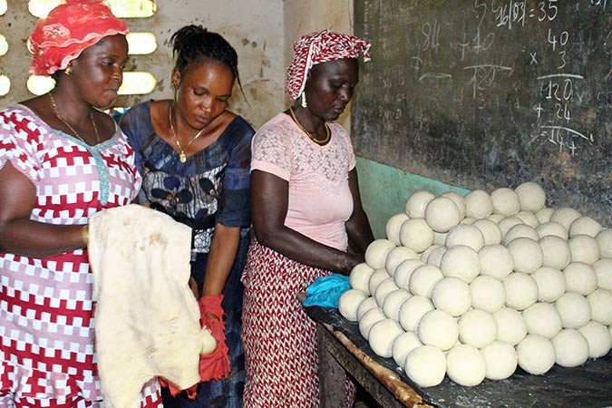 Pauline and two friends making soap in Guinea.