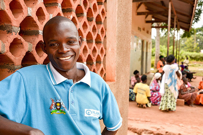 Naika, a farmer in Uganda, wearing a Plan International t-shirt.