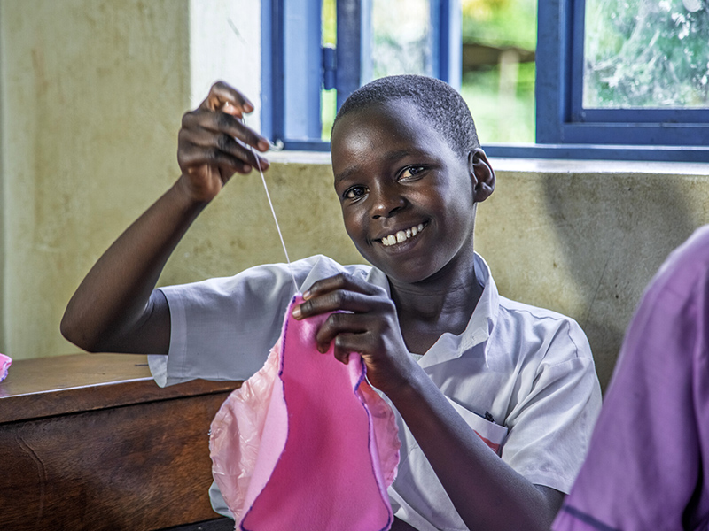 Melisha, 13, makes a reusable sanitary pad at her school in Uganda.