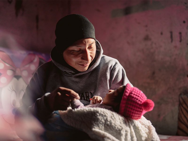 Marco, 26, cares for his newborn daughter.