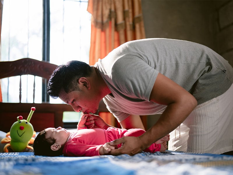 Kevin kissing his baby daughter's hand