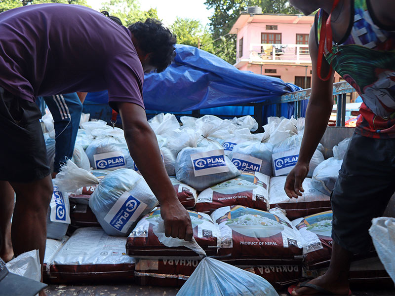 Aid bags for people affected by Nepal floods being loaded on to a truck