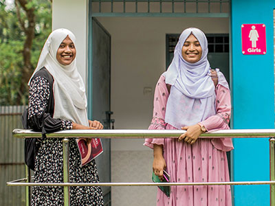 Ria, 17, and Shifla, 15, in front of the new school wash block