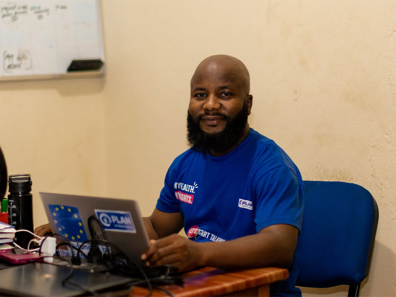 Abdulai Tunkara working on a laptop at his desk