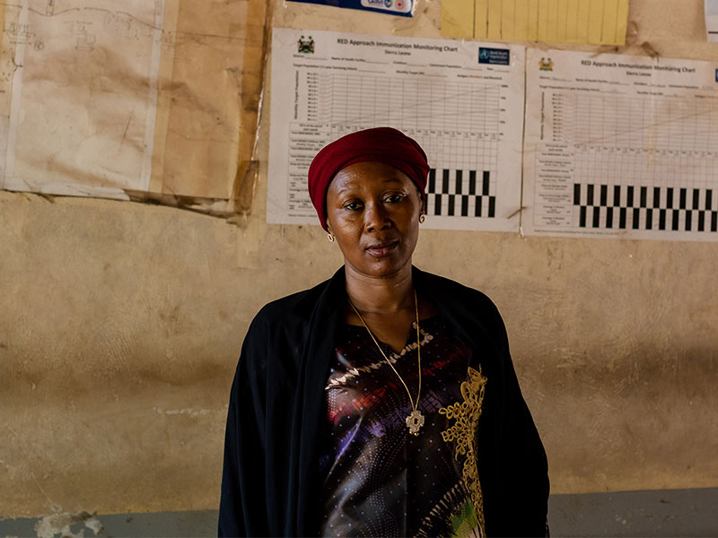 Mariatu standing in front of wall that has charts/ diagrams on it