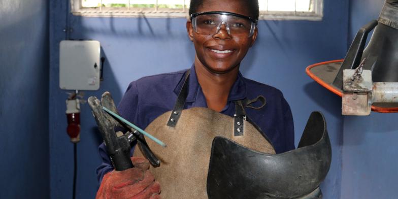 Jennifer, 20, welding with a blow torch in a workshop in Kenya