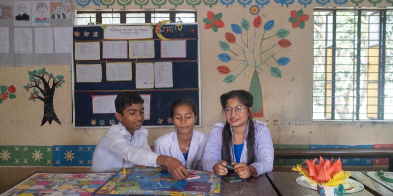 Akhimoni, 15, playing board games with her friends at school in Bangladesh