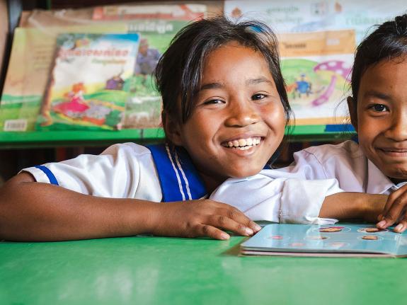 Len Sokha, 10, and her best friend Sok Na in the school library 