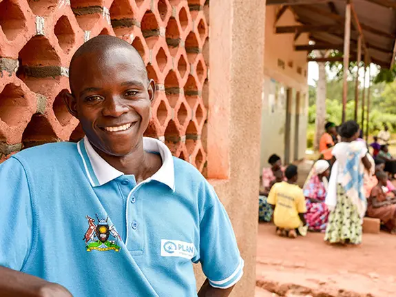 Naika, a farmer in Uganda, wearing a Plan International t-shirt.