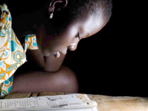 A girl reads from her school book