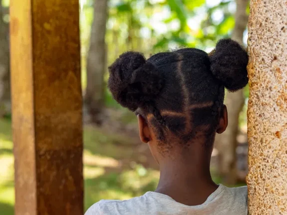 In 2021, escalating gang violence forced 31-year-old Marie* to flee Haiti’s capital, Port-au-Prince, with her two children, Junior*, 15, and Teta*, 13. Teta* (pictured) went on to experience sexual harassment and exploitation.