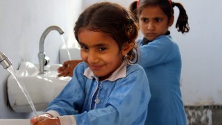 Girls wash hands at school