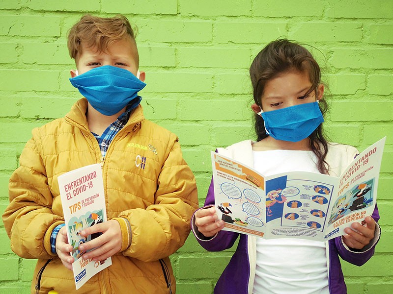 Photo of two children reading leaflets