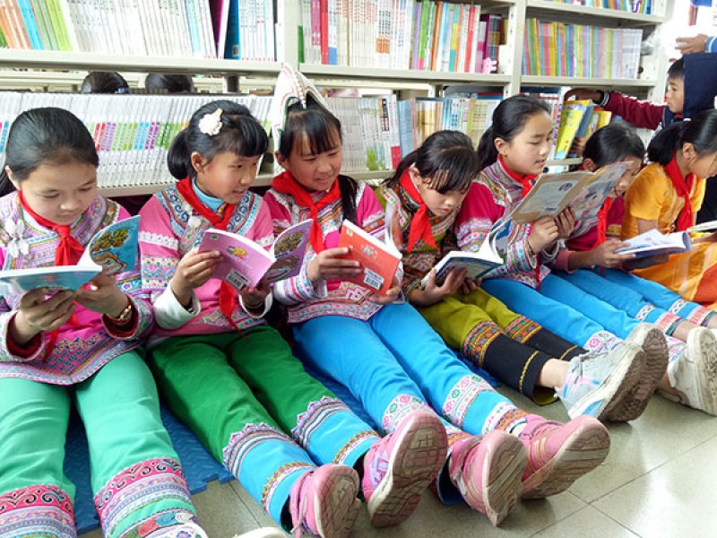 Girls read books at a school library