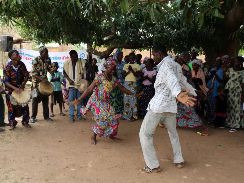 community members sing and dance at a ceremony to abandon FGM