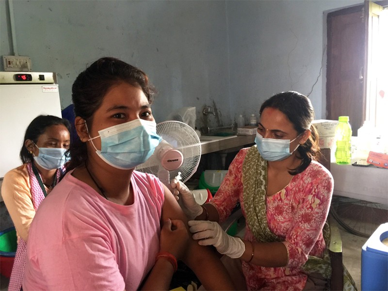 Young woman receives a vaccine in a health centre