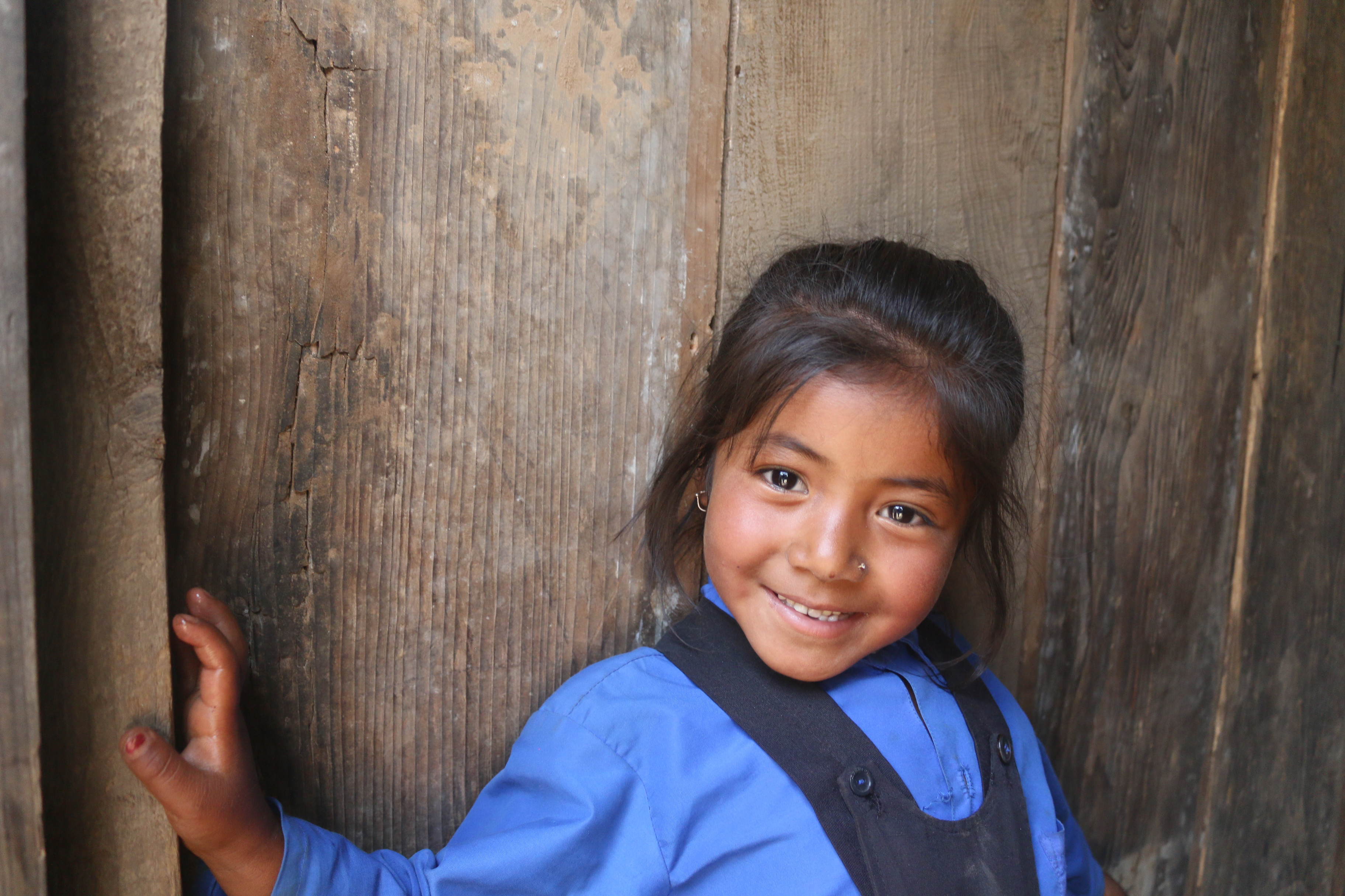 Child smiles in her school uniform 