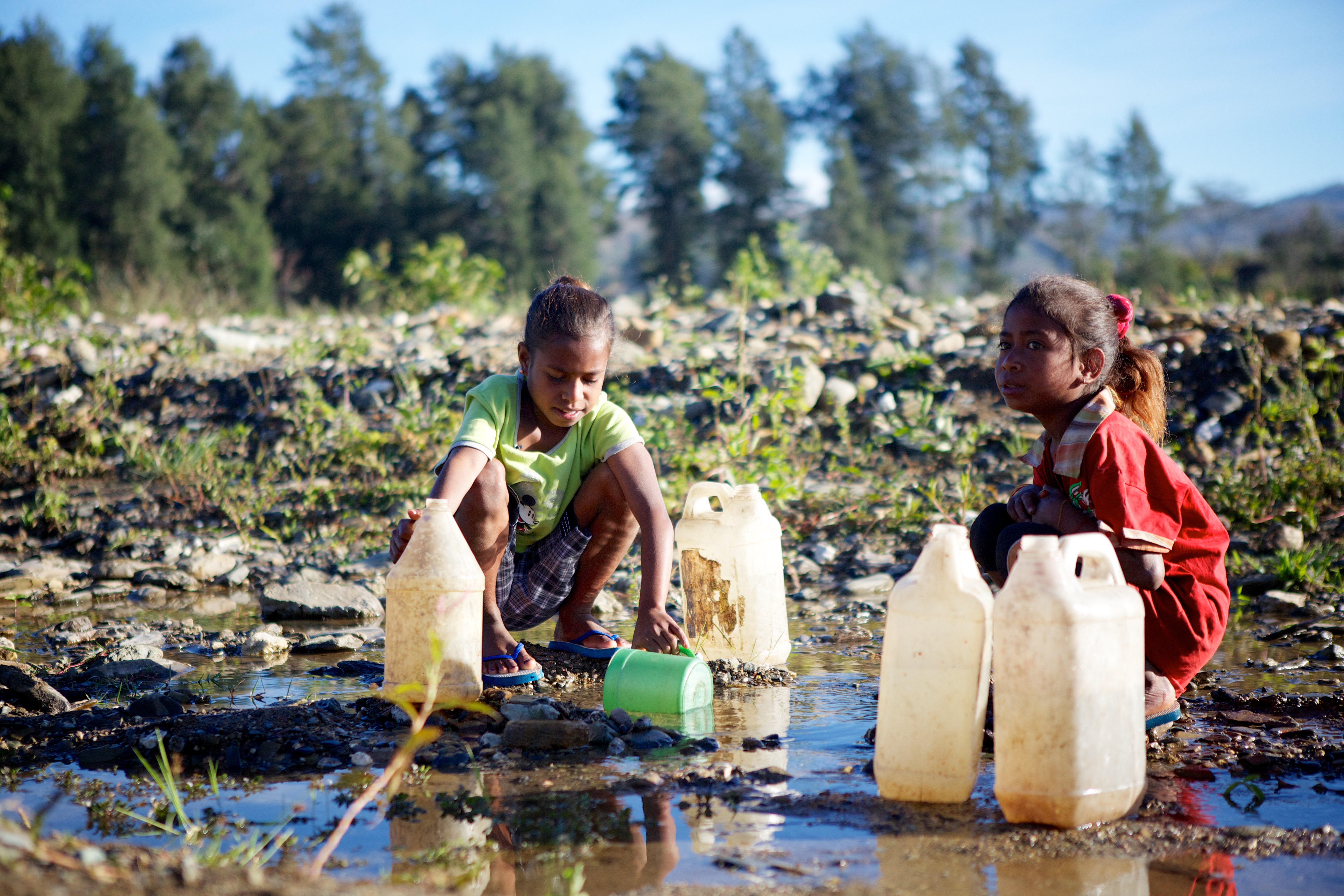 Children collect dirty water