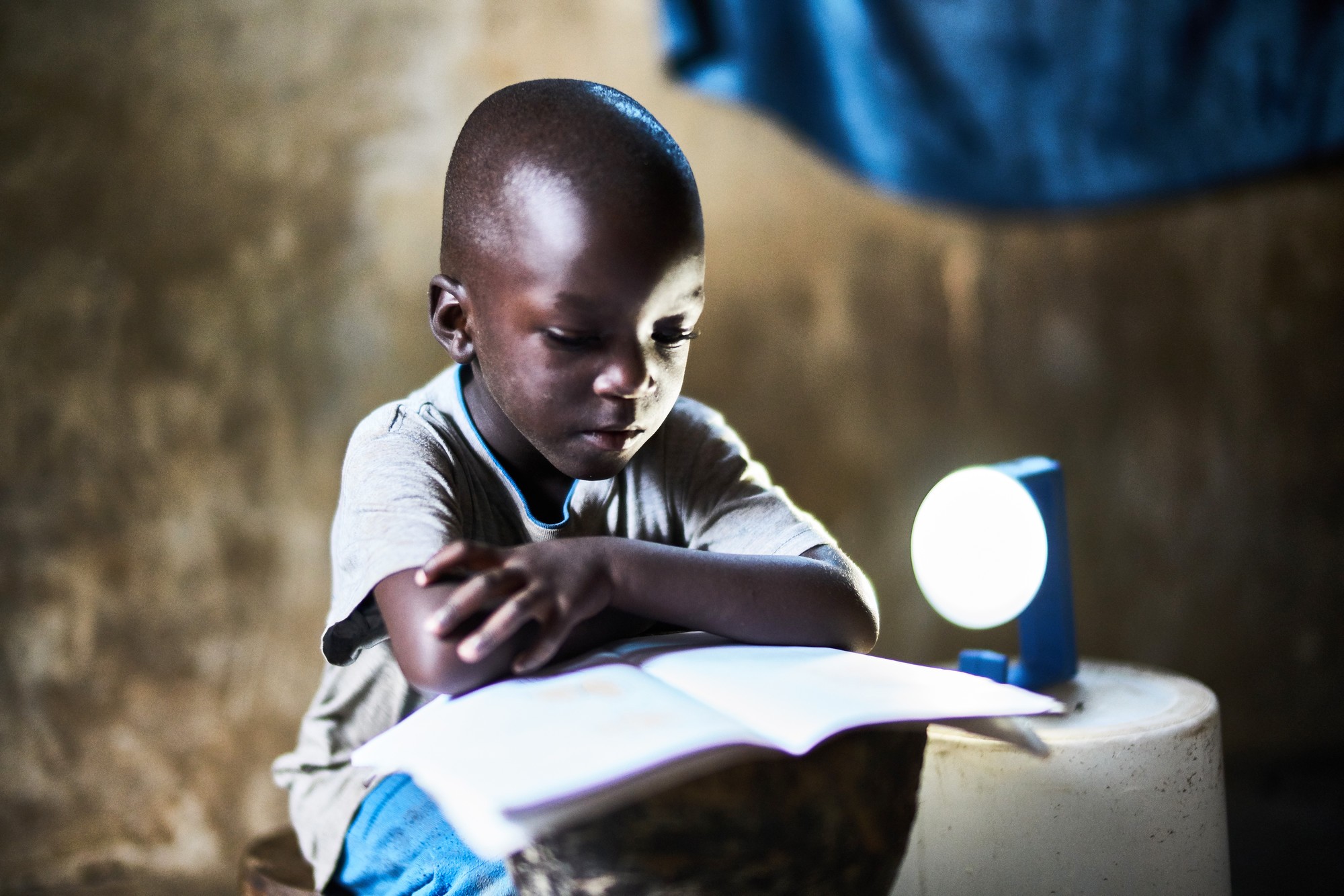 Young boy studying with handheld solar Natural Light lamp