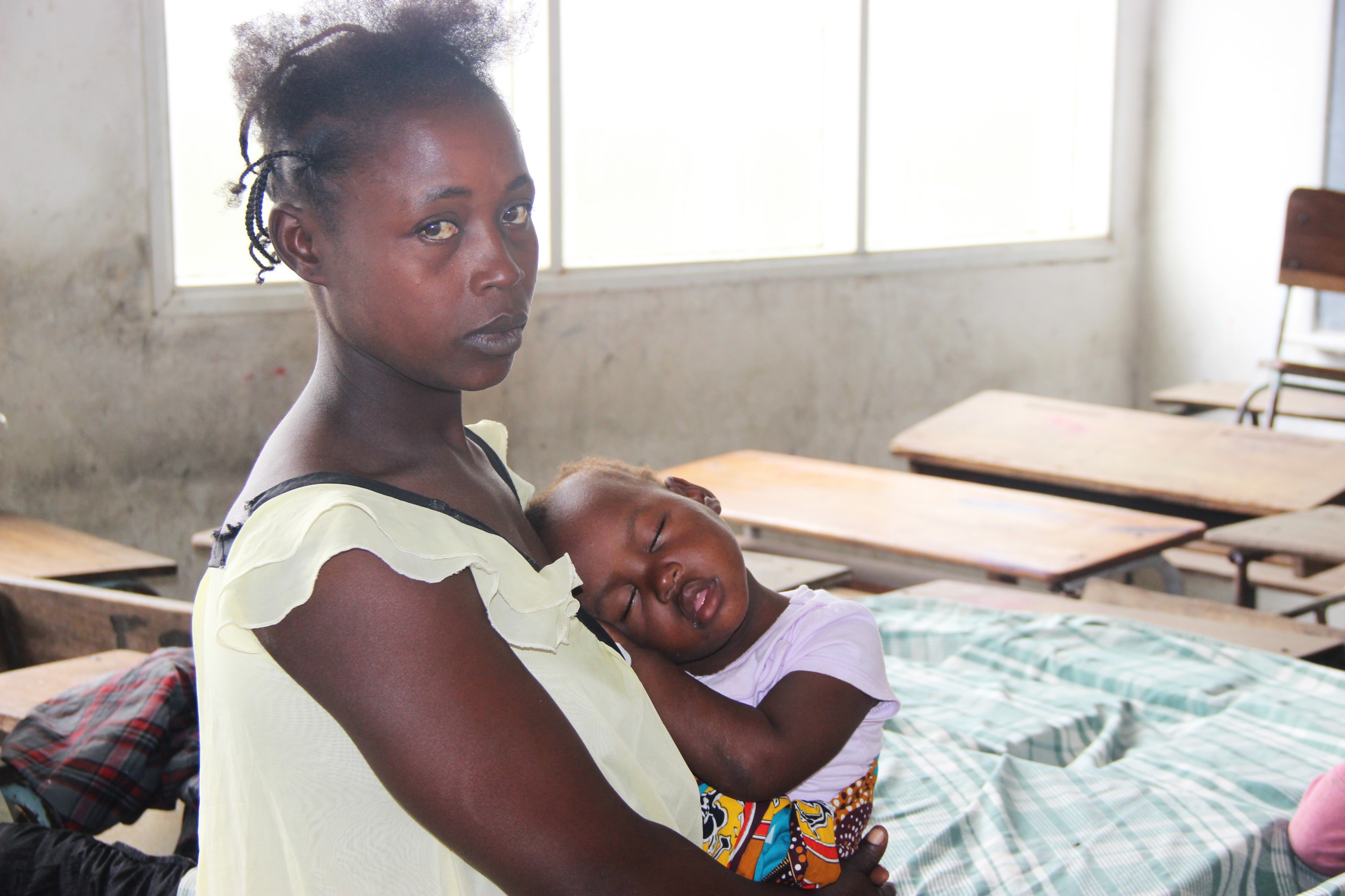 A mother and child living in a school which is being used as a shelter in Mozambique