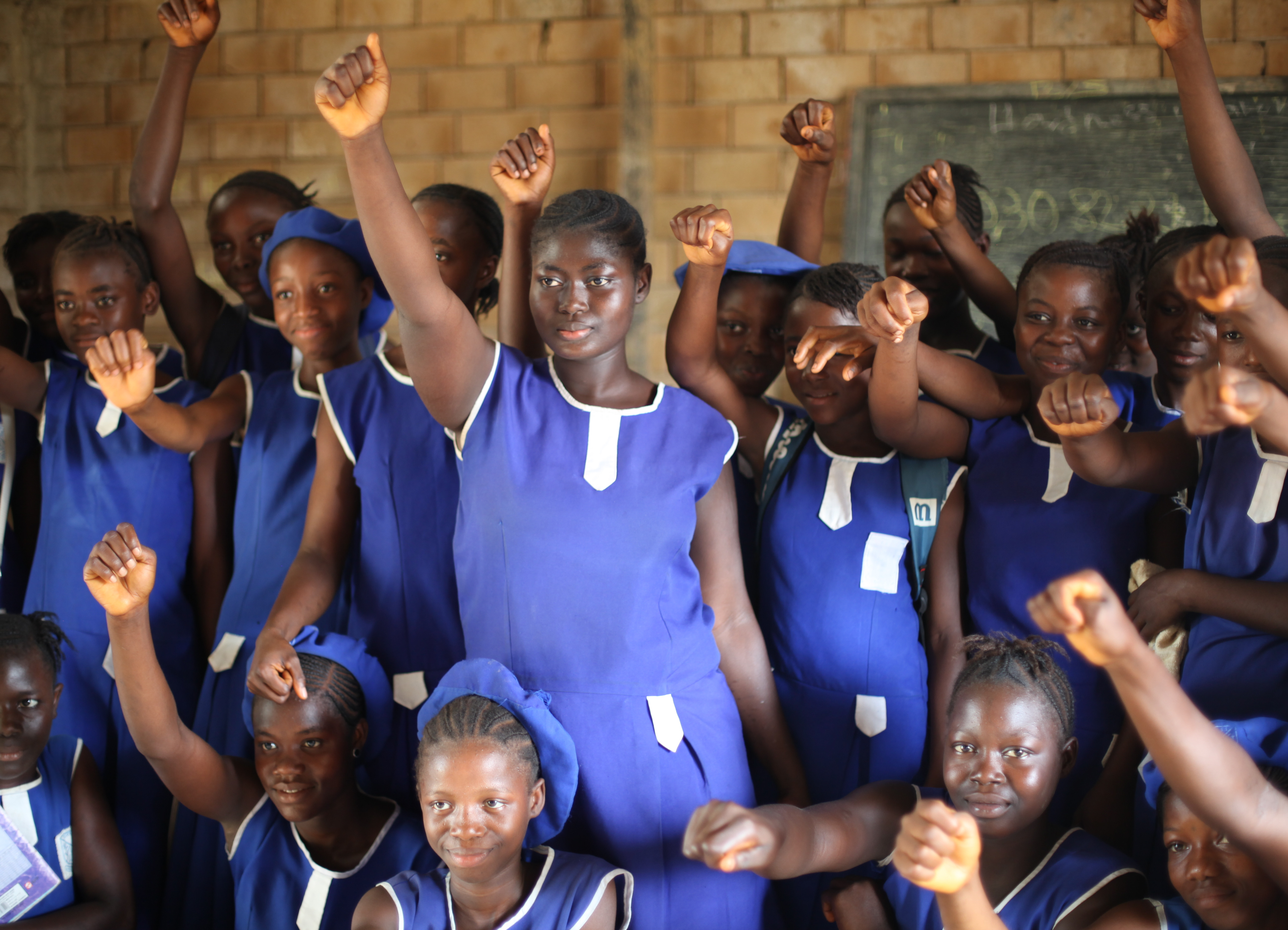 girls raise their hands against FGM