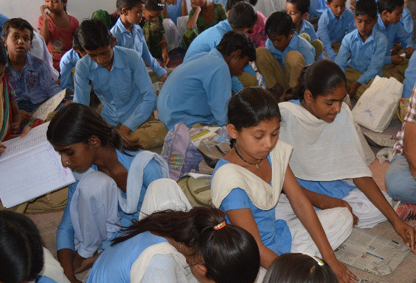 Children making paper bags at their Financial Education and Life Savings club in Bikaner, India