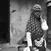 Ghana-Rose stands in front of her home