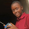 Photo of a girl in a red top holding a radio