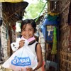 Photo of a girl holding a hygiene kit