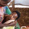 Burundi refugee mum smiles at her baby