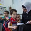Syrian mum reads to her child