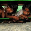 Children hide under tables after a disaster drill rings