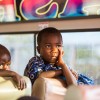 Burundian refugee children on board bus to transfer them to Nduta camp