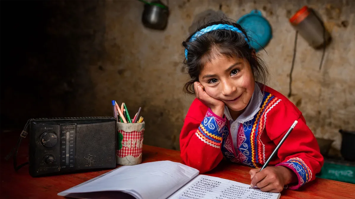 Zenaida, 6, doing homework at table. 
