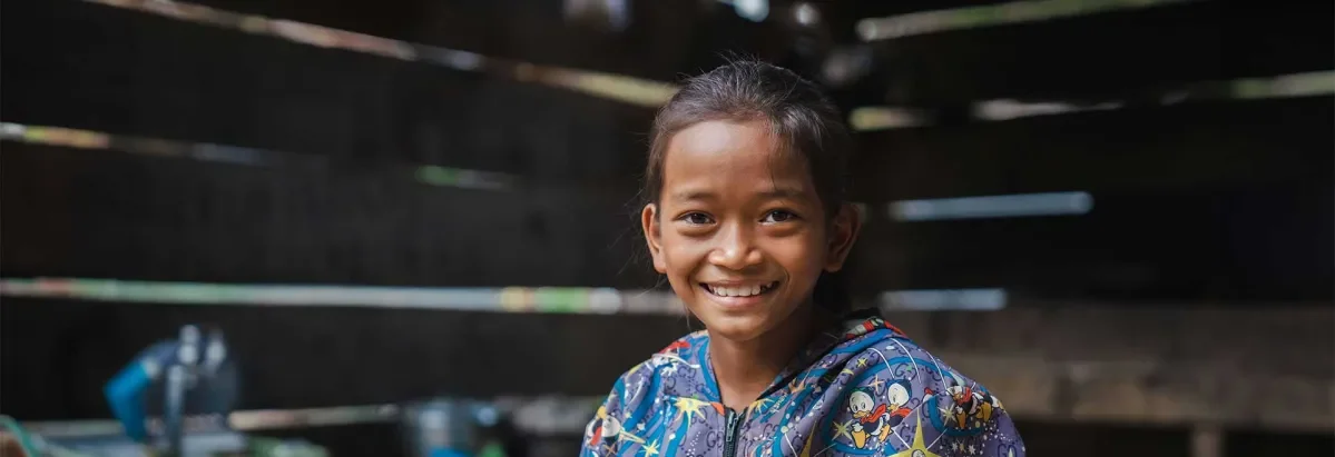 Ky Sokly at home smiling at camera