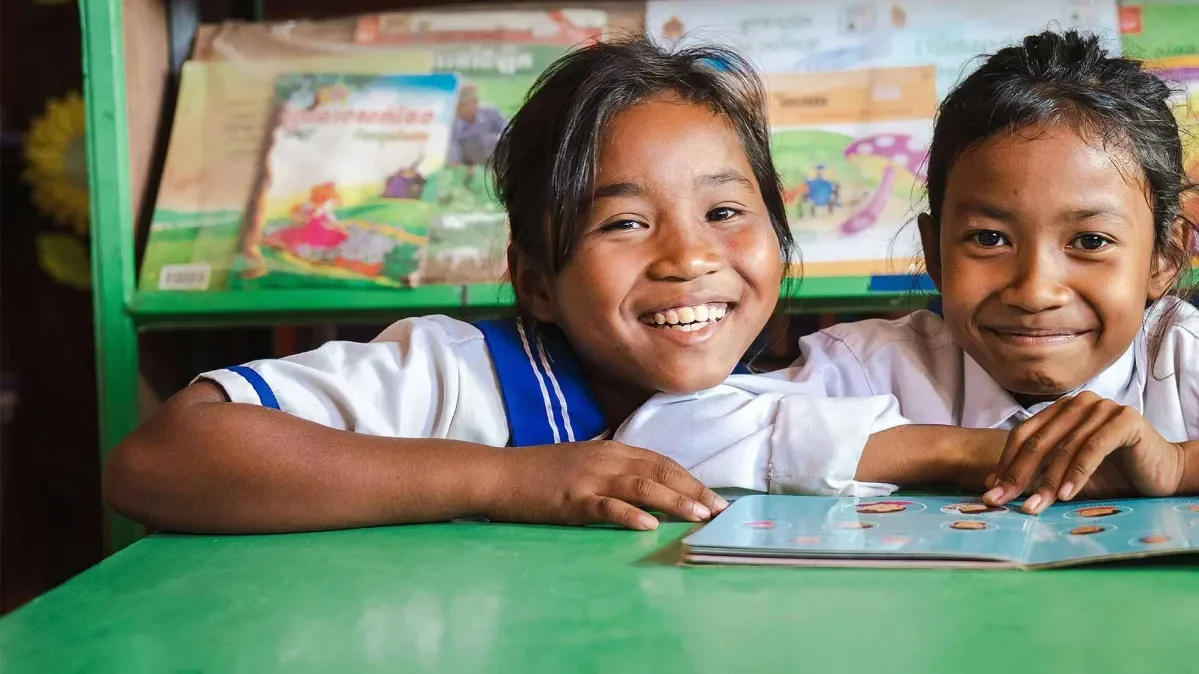 Len Sokha, 10, and her best friend Sok Na in the school library 