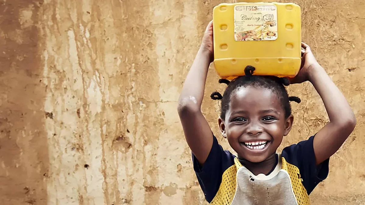 Girl smiling and holding box above her head