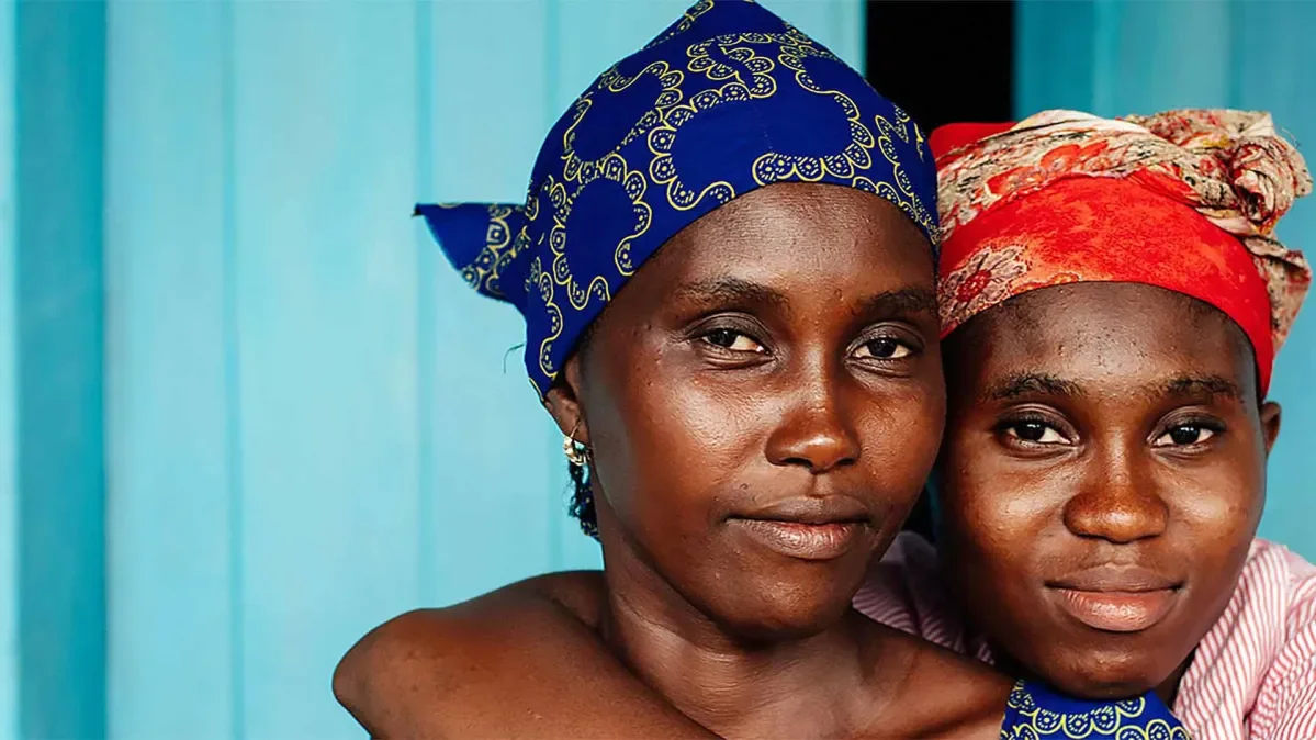 Two young women from Sierra Leone smiling at the camera