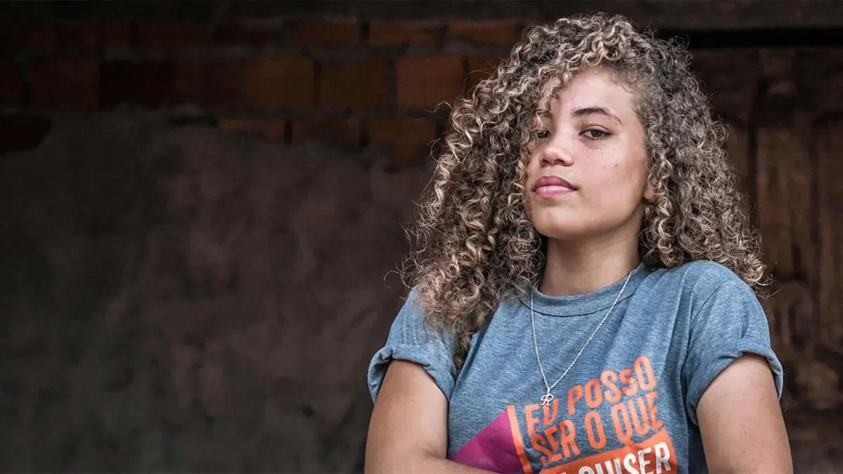 A girl with her arms crossed looking at the camera