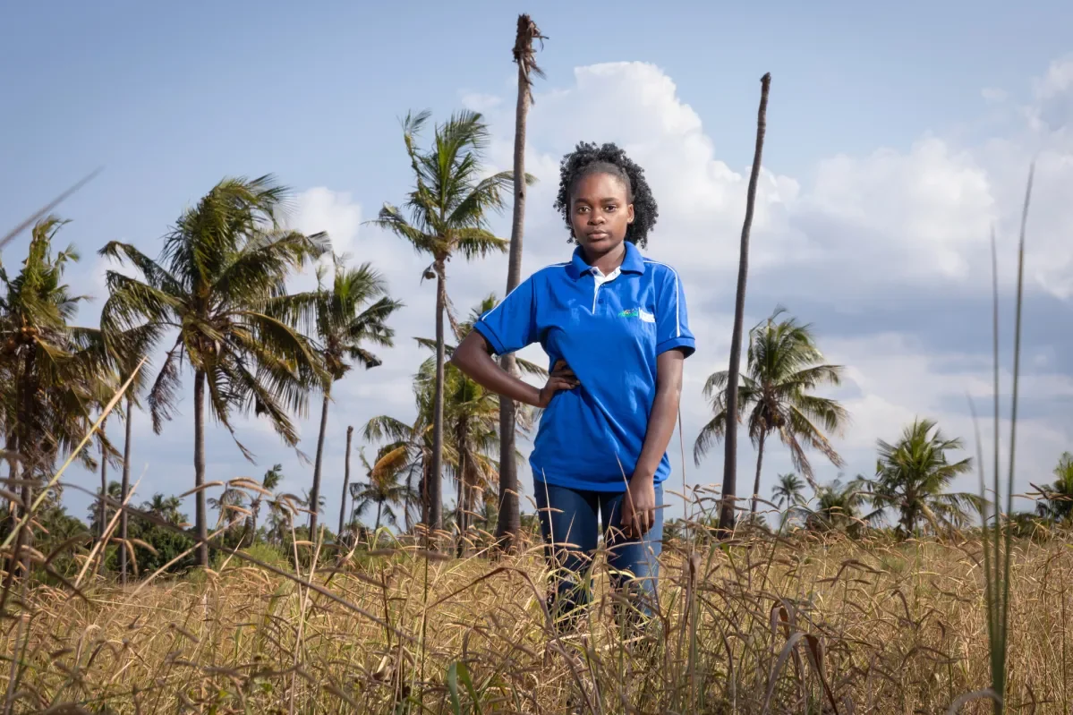 Eunice, 18, stands in a field in Mozambique. She is passionate about defending the rights of girls 