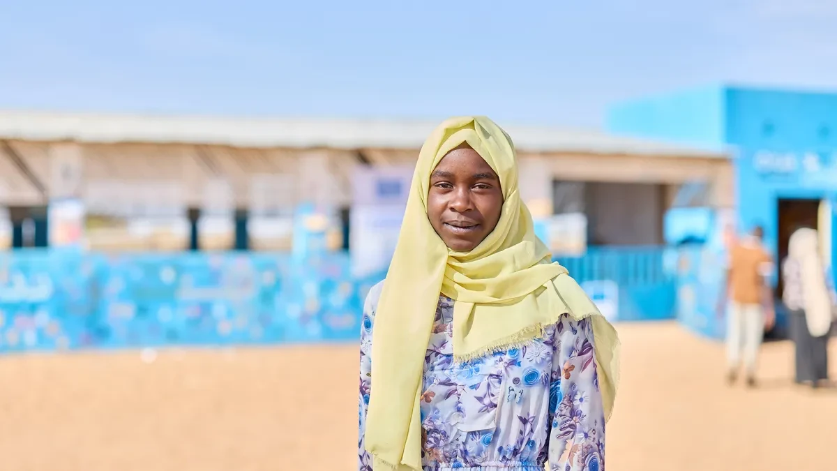 Rania, 15, from western Sudan, stands in a child-friendly space in a refugee camp.