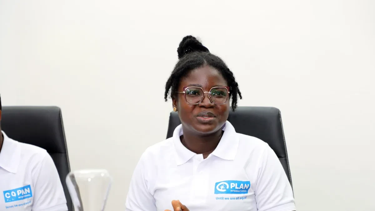 Benedicta sat in conference room speaking